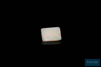 an oplite stone on a black surface with a black background