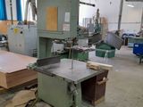 a machine that is working on a piece of wood in a factory