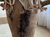a vase that has a piece of wood on it
