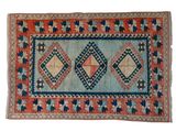 a blue and orange rug with a diamond design on it