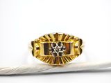 a close up of a ring with a feather on a white surface