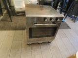 a stove that is sitting in the middle of a kitchen