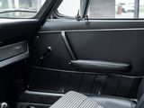 a black car with a wooden steering wheel and dashboard