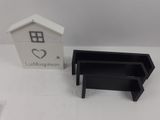a small black and white box and a small black and white house