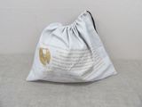 a white bag with a gold logo on it