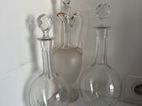 three glass vases sitting on a white counter