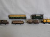 several toy trains are lined up next to each other on a white surface