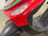 a red scooter with a green stripe on the front