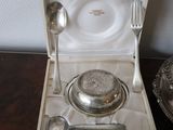 a silver plate with spoons and a bowl in it