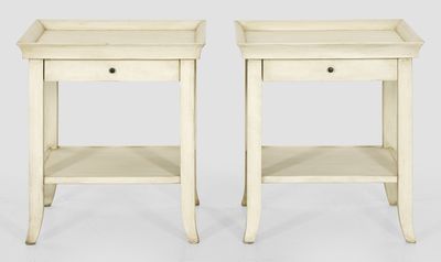a pair of white side tables with drawers on each side