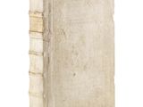 an old book sitting on top of a white surface