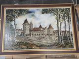 une photo d'un tableau représentant un château, posé sur un chevalet