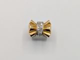 a close up of a gold and diamond bow ring