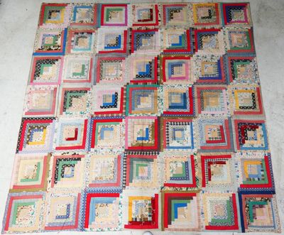 a large patchwork quilt on the floor on the floor
