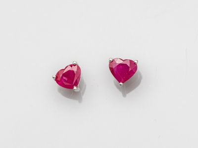 a pair of pink heart shaped earrings on a white background