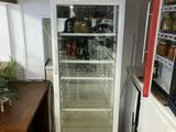 a refrigerator that is sitting in the corner of a kitchen