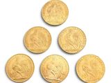 six gold sovereigns in a pyramid on a white background