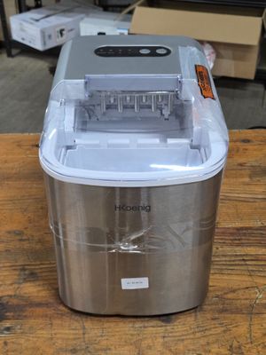 a small ice maker sitting on a wooden table