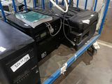 two computers and a printer on a cart in a warehouse