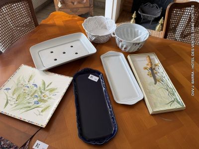 many plates and trays sitting on a wooden table