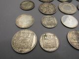 some old coins are sitting on a table with a black background