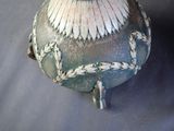 a vase that is sitting on a table with a blue background