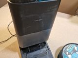 a soda dispenser sitting on a counter next to a cd player