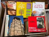 many books that are in a box on the floor