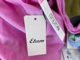 a close up of a pink cloth with a tag on it