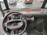 a dashboard of a small car with a steering wheel