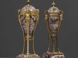une paire de vases sur socles, ornés de motifs violets et dorés