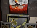 three framed pictures of birds on display in a room