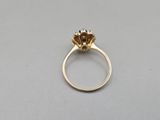a close up of a gold ring with a flower on it
