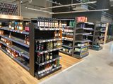 many shelves in the store that have alcohol on them