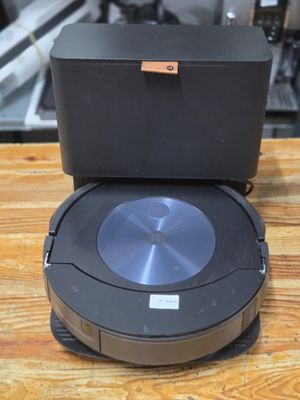 an image of a robotic vacuum cleaner sitting on top of a wooden table