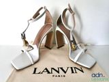 an image of a pair of white high heeled shoes on a bag