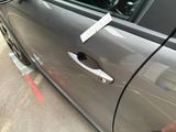 a silver car with a sticker on the side of it