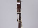 a close up of a bassoon on a clear acrylic stand