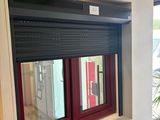 a large window with a red frame in the middle of a room