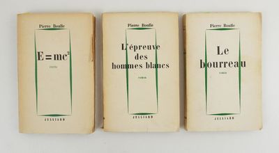 three books sitting on top of a white table next to each other