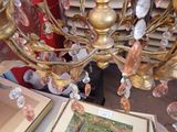 a gold chandelier with crystal beads hanging from it