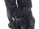 a black statue of two people with a dog and a basket