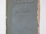 an old book with writing on it sitting on top of a table