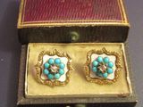 a small box that has two pairs of earrings in it
