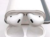 two airpods sitting on top of a charging case