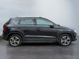 the black volkswagen suv is parked in a parking lot