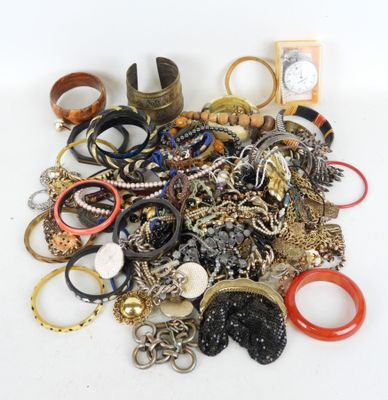 a pile of assorted rings and bracelets on a table