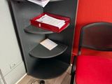 a red chair next to a black desk with a red chair next to it