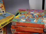 many books stacked on top of each other on a table