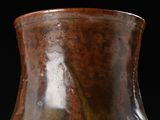 a brown vase that is sitting on a table